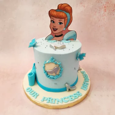 Princess-themed birthday cake with a character topper and decorative fondant accents.