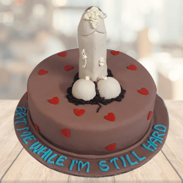 A chocolate cake with a dildo on it