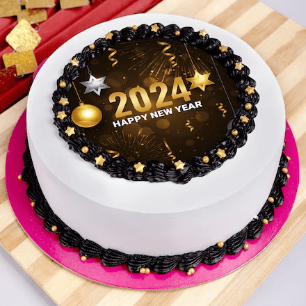 A New Year 2024 celebration cake with black and gold decorations on a white icing base.