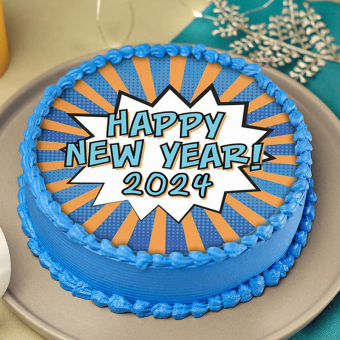 A blue New Year-themed cake with a festive comic-style explosion design saying "Happy New Year! 2024