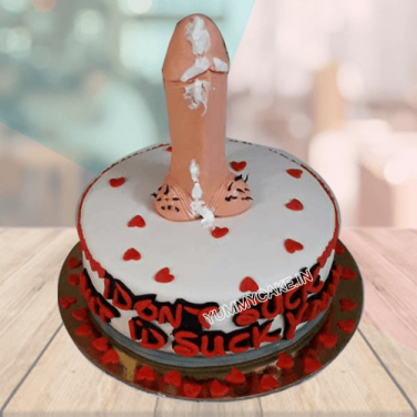 A pink cake with a dick on top of it.