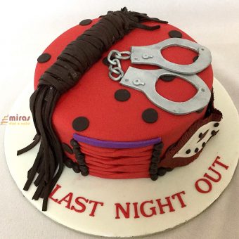 A ladybug cake with handcuffs on it