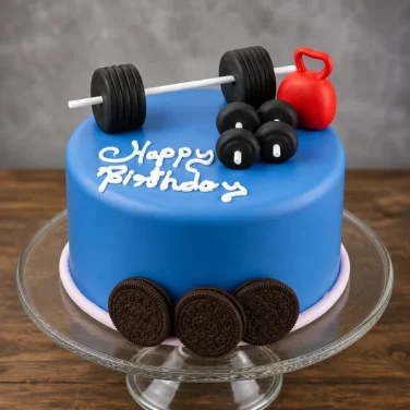 Blue birthday cake topped with a barbell, dumbbells, red kettlebell, and an Oreo cookie base.