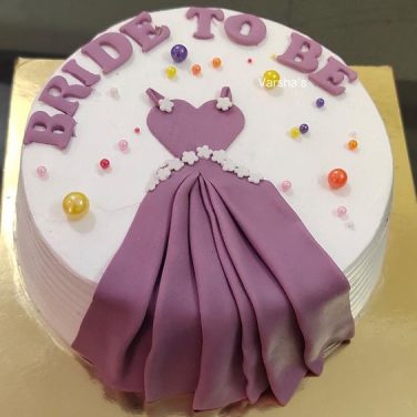 A bride to be cake with a purple dress on it