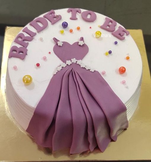 A bride to be cake with a purple dress on it