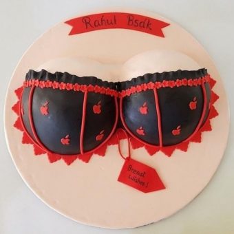 A cake decorated like a bra with red and black stripes