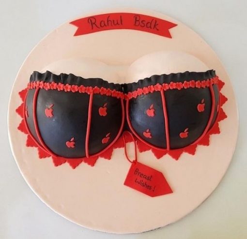 A cake decorated like a bra with red and black stripes