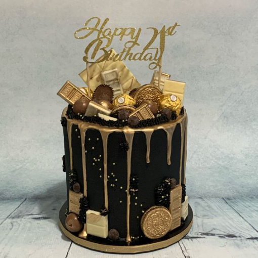 gold chocolate drip cake with chocolates