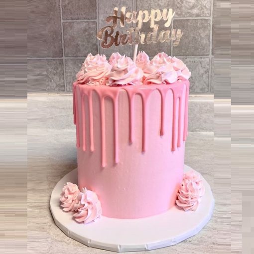 pink drip cake with birthday topper