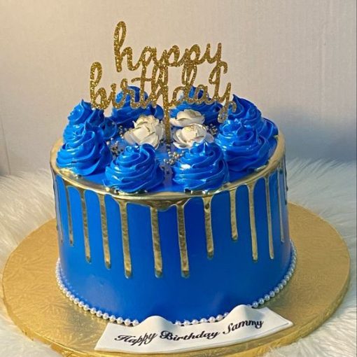 royal blue drip cake with birthday topper
