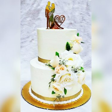 2 tier white cake with fresh flowers or roses