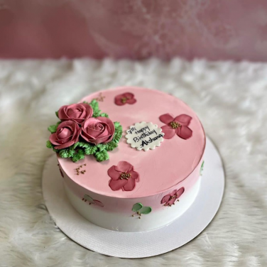 pink and white cake with flowers
