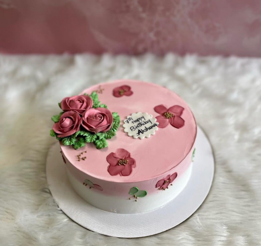 pink and white cake with flowers