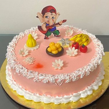 cake with ganesh photo and small fondant designs on top