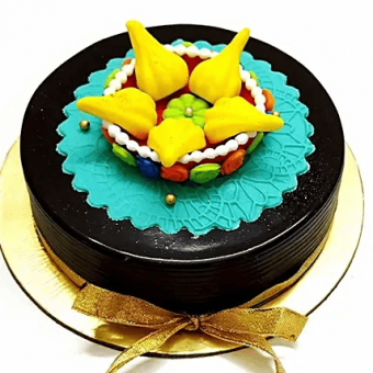 A chocolate cake with fondant modak on top