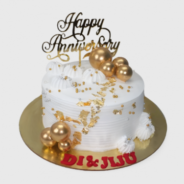 anniversary cake with gold balls on the top