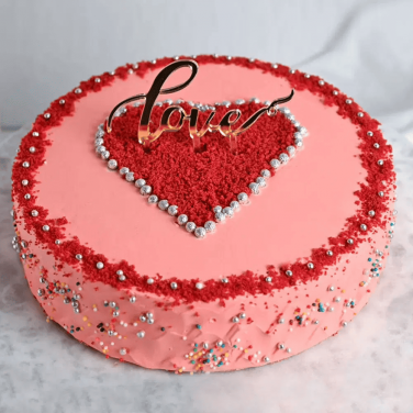 pink colored round cake with heart design