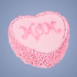 Heart-shaped pink Mother’s Day cake with “MOM” written in decorative icing