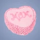 Heart-shaped pink Mother’s Day cake with “MOM” written in decorative icing