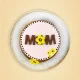 Mother’s Day cake with “MOM” text and yellow flower decorations on pink frosting