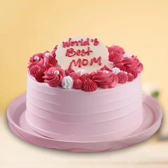 Pink Mother’s Day cake with “World’s Best Mom” message and red-white cream decorations