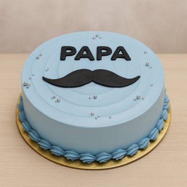 Blue cake with “Papa” and moustache design
