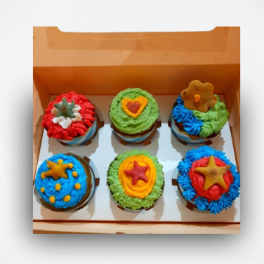 Box of colorful star-decorated cupcakes for dogs