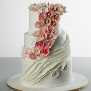three tier white wedding cake with flowers
