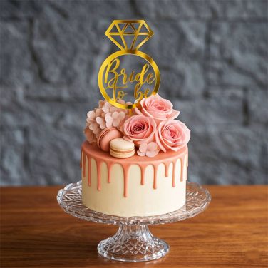 bride to be drip cake with floral topper