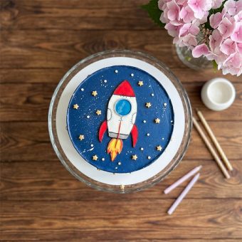 galaxy rocket cake with gold stars top view