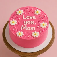 Pink minimalist cake with "Love you, Mom" text and daisy flowers