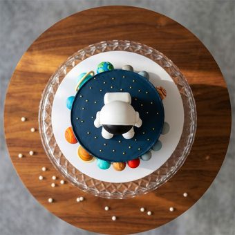 solar system galaxy cake with astronaut top view
