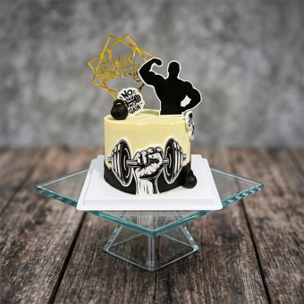 Cream and black two-tone cake with bodybuilder silhouette and hand gripping a dumbbell graphic.