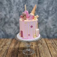 Pink 2nd birthday cake with a teddy bear, ice cream cone, and popsicle toppers.