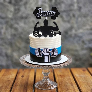 White, blue, and black striped cake with weightlifter silhouette and custom name topper.